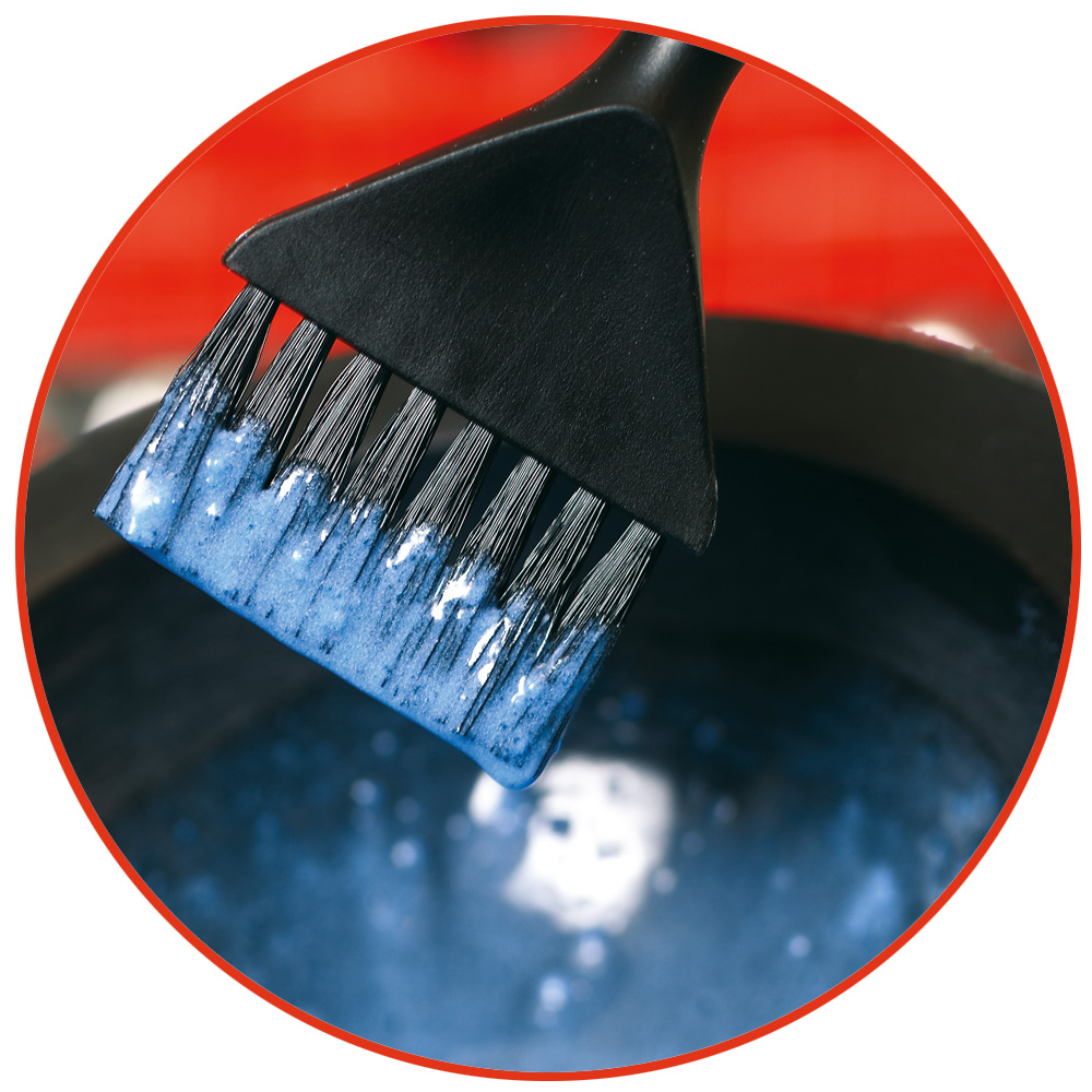 Ein Pinsel mit bläulichem Haarfärbemittel
