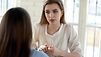 A little bit nervous. Worried stressed young woman job applicant trying to keep calm and make good impression on female hr recruiter at interview, feeling insecure, afraid to give incorrect answer